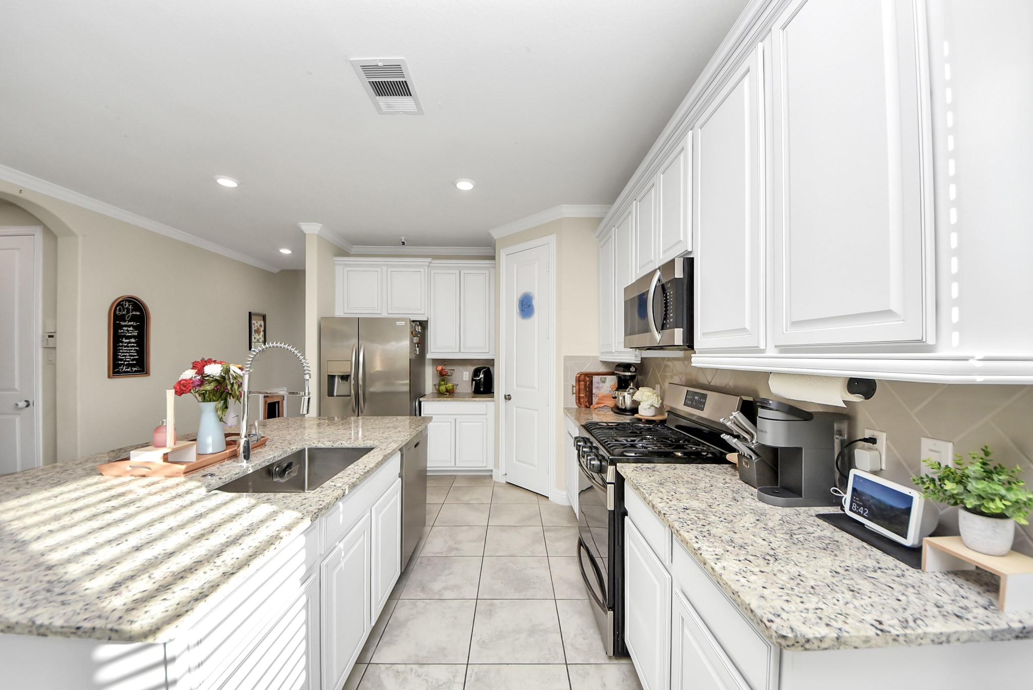 6703 Sandia Crest Street Spring, TX 77379 - Photo 10 of 45 a kitchen with stainless steel appliances granite countertop a sink stove and refrigerator