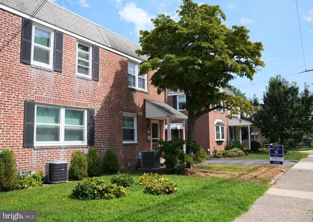 a front view of a house with a yard and porch