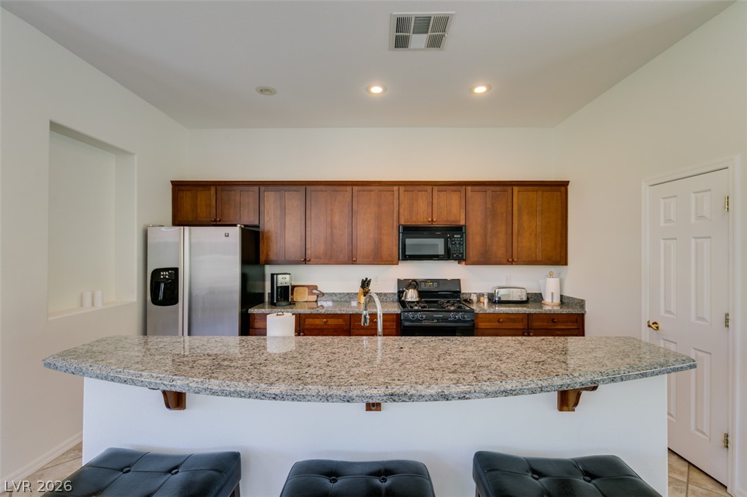 8 Kennesaw Road Henderson, NV 89052 - Photo 22 of 44 Gleaming granite countertops define this bright, functional kitchen space.