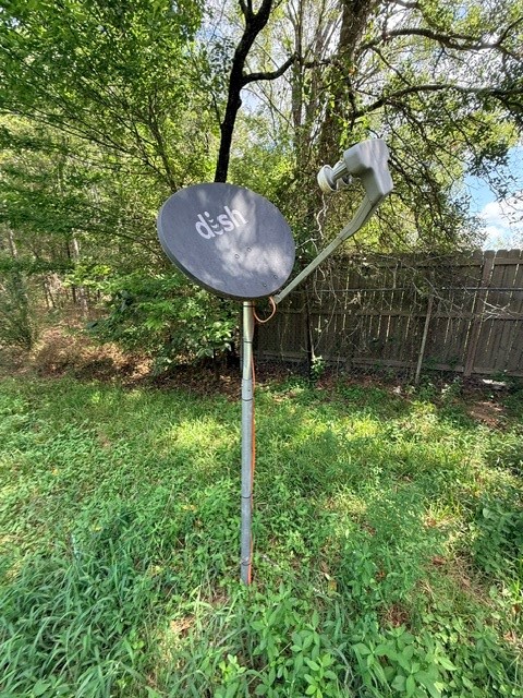 58 Roy Webb Road Huntsville, TX 77320 - Photo 17 of 31 Satellite dish in the yard behind the brick home.
