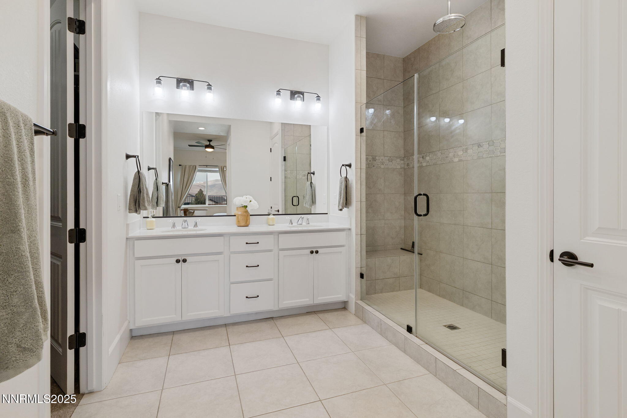 3011 Silverberry Lane Reno, NV 89521 - Photo 11 of 25 a bathroom with a shower a sink and a mirror