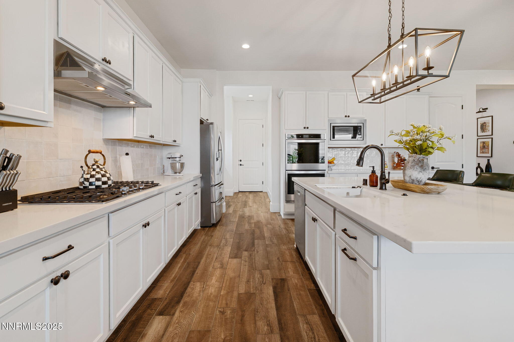 3011 Silverberry Lane Reno, NV 89521 - Photo 6 of 25 a kitchen with kitchen island granite countertop lots of counter top space and stainless steel appliances