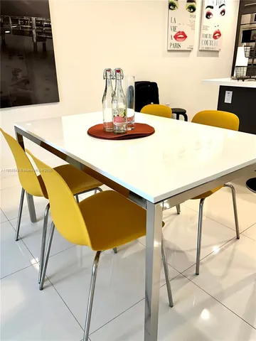 a living room with a table and chairs