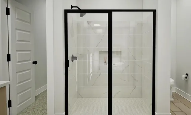 a bathroom with a glass shower door