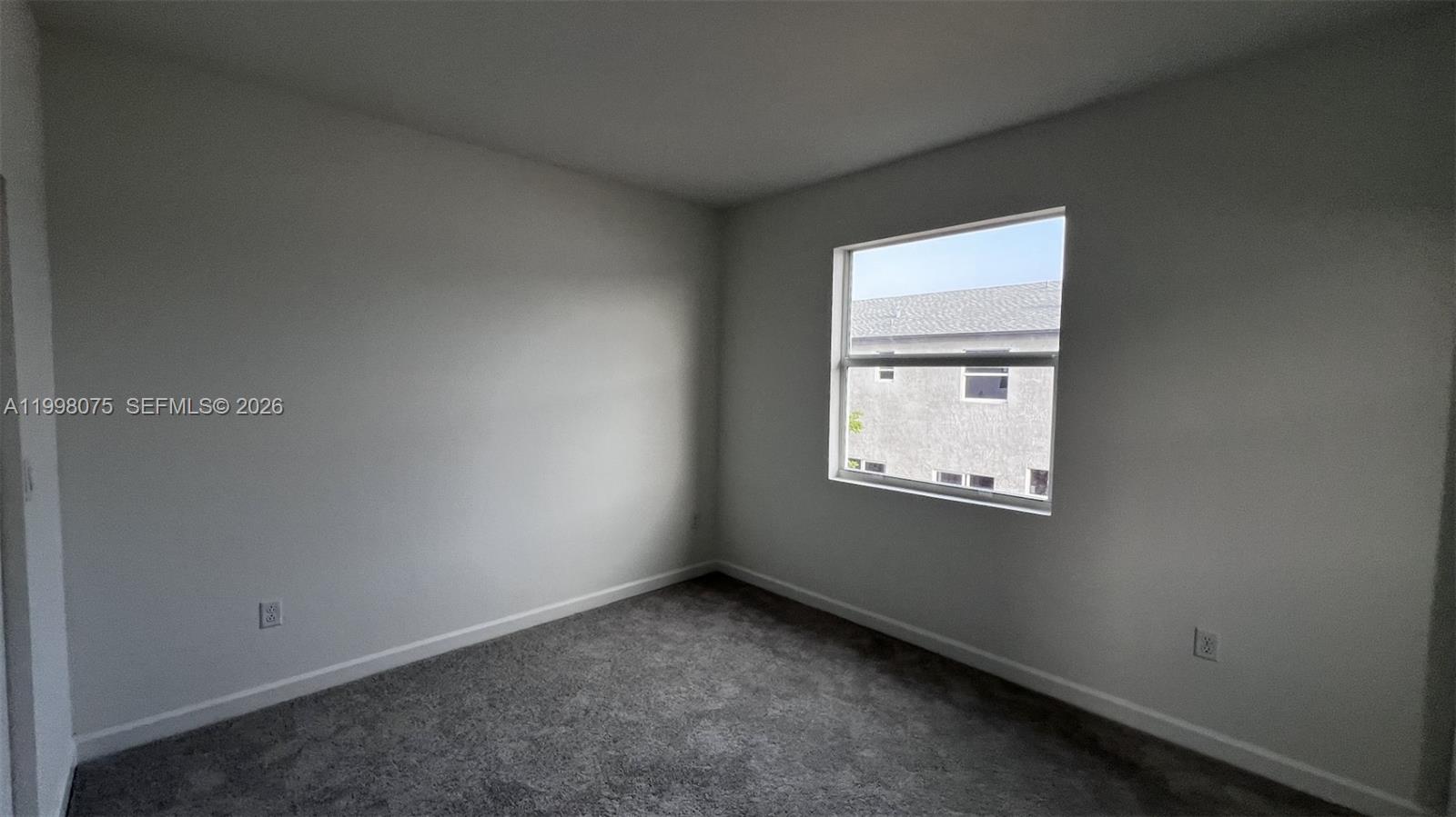 15583 Southwest 277th Street, Unit 15583 Homestead, FL 33032 - Photo 18 of 27 an empty room with a window