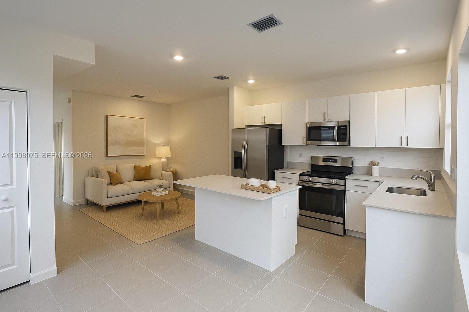 15583 Southwest 277th Street, Unit 15583 Homestead, FL 33032 - Photo 5 of 27 a kitchen with white cabinets and stainless steel appliances