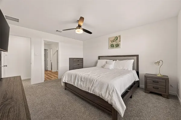 a bedroom with a bed and a tv on table