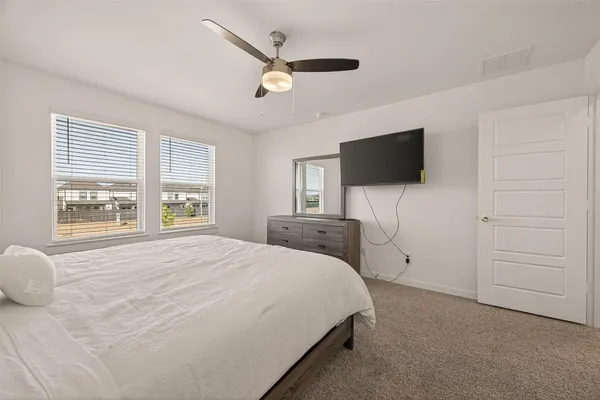 a bedroom with a bed and a flat screen tv