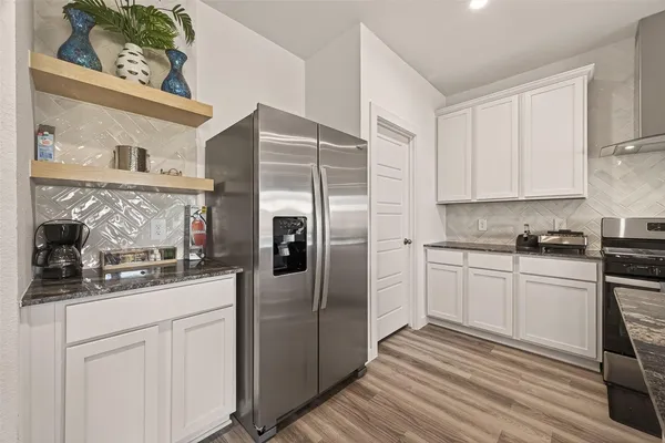 a kitchen with cabinets and stainless steel appliances