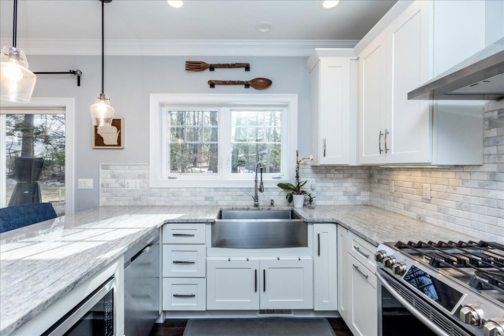 6 Harnden Road Billerica, MA 01821 - Photo 8 of 42 a kitchen with cabinets appliances a sink and a counter top space