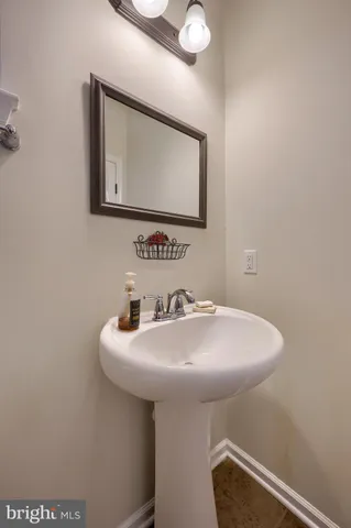 a bathroom with a sink a mirror and a toilet