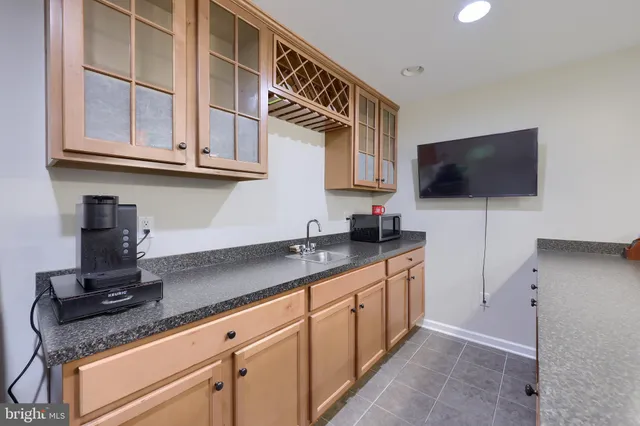 a kitchen with stainless steel appliances granite countertop a sink and a microwave