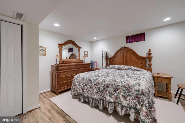 a bedroom with a bed and a dresser