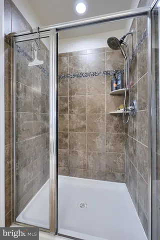 a bathroom with a shower and a sink