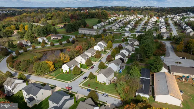 an aerial view of residential houses with outdoor space