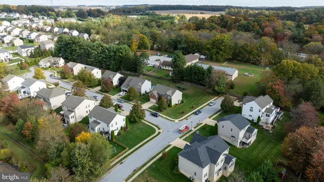 an aerial view of a residential houses with outdoor space