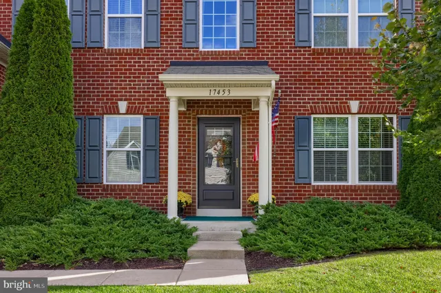 a front view of a brick house with a yard