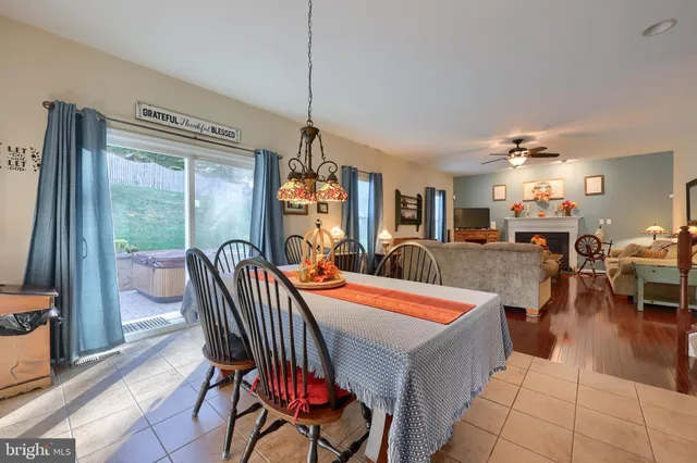 a dining room with furniture a chandelier and window