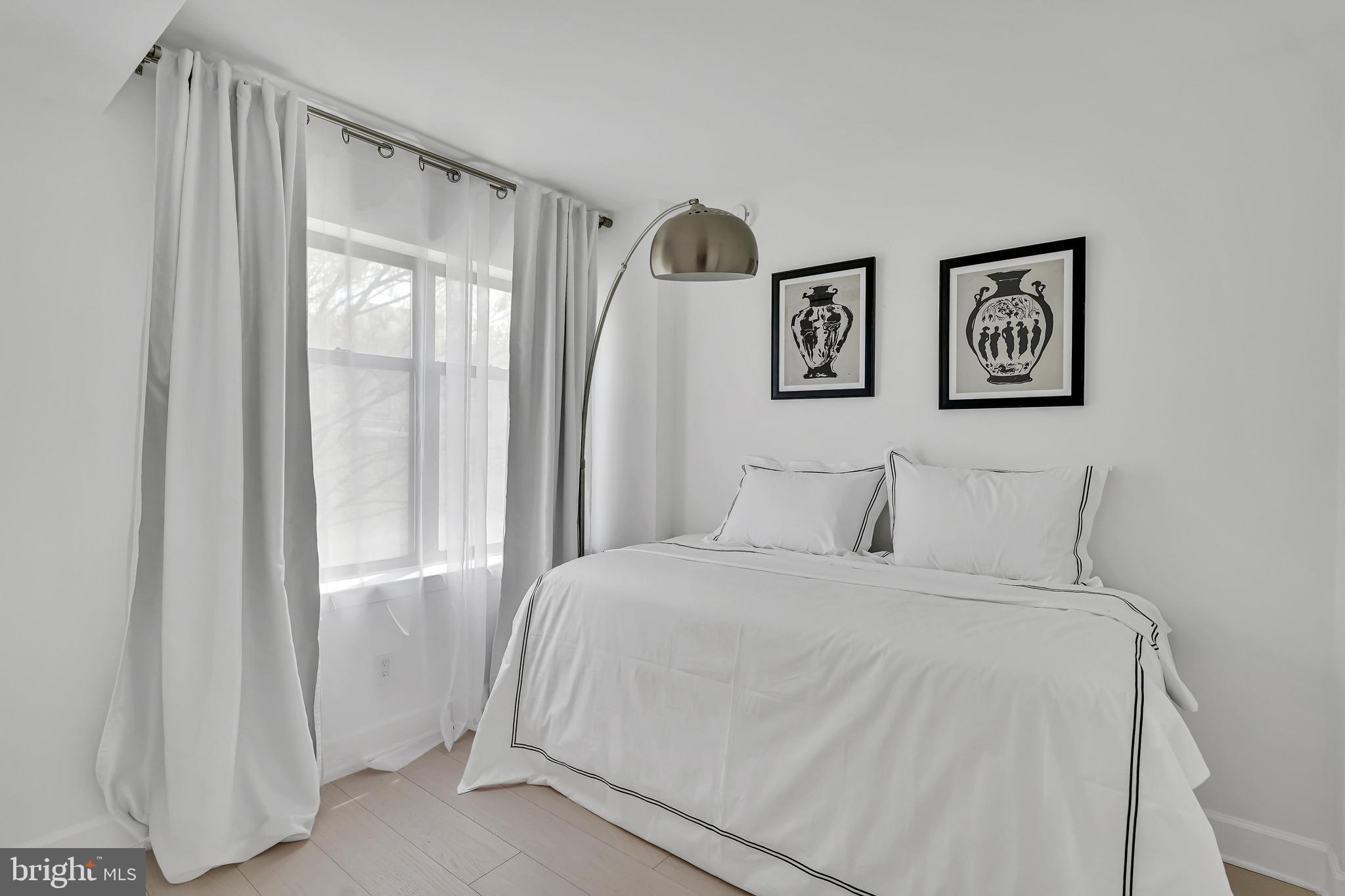 3401 38th Street Northwest, Unit 407 Washington, DC 20016 - Photo 17 of 37 a bedroom with a bed and a window