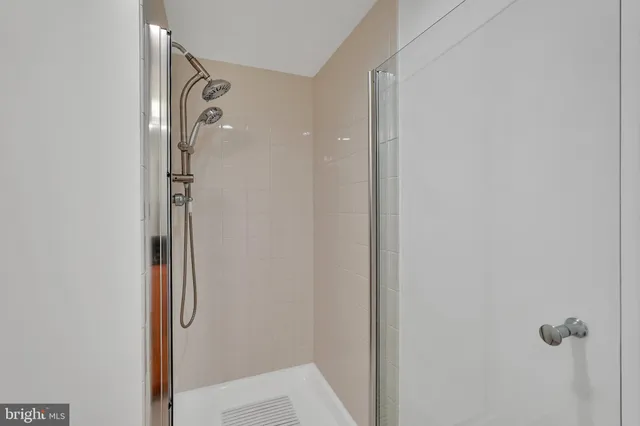 a bathroom with a glass shower door
