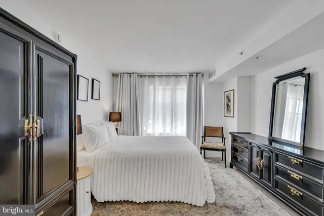 a bedroom with a bed next to a window