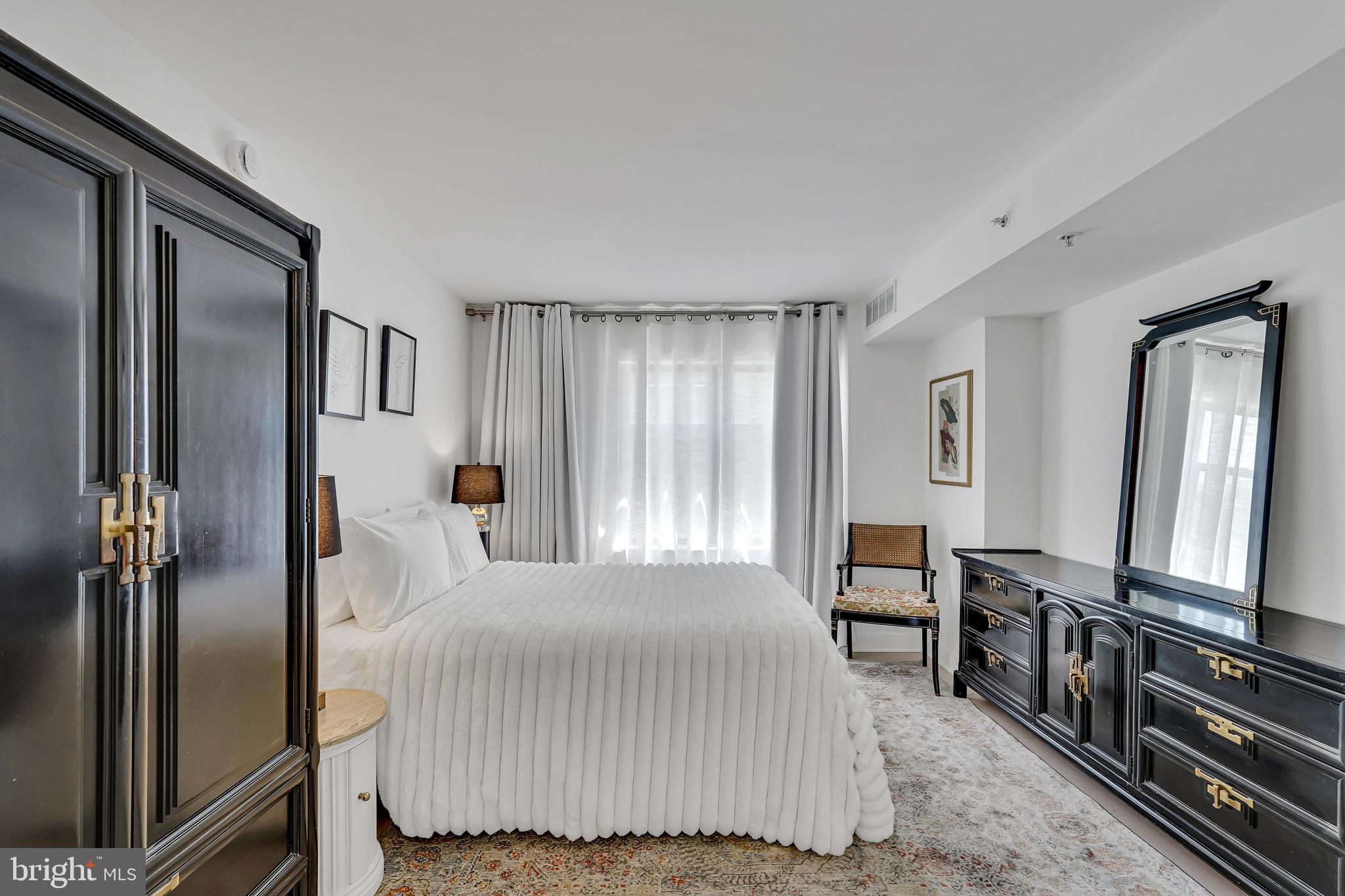 3401 38th Street Northwest, Unit 407 Washington, DC 20016 - Photo 21 of 37 a bedroom with a bed next to a window