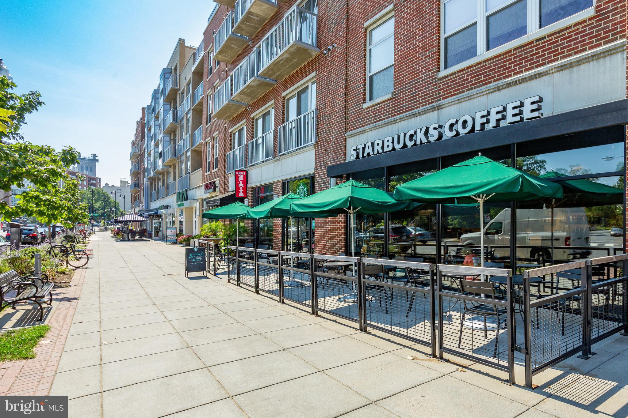 3401 38th Street Northwest, Unit 407 Washington, DC 20016 - Photo 33 of 37 a view of a cafe with a table and chairs under an umbrella