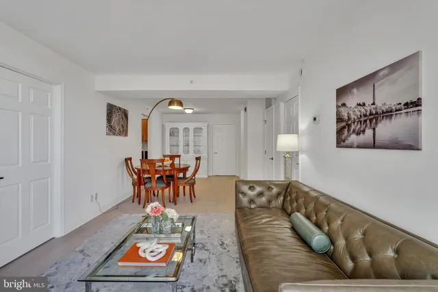 a living room with furniture and a dining table