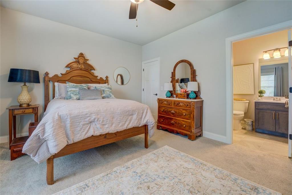 616 Haven Way Monroe, GA 30655 - Photo 21 of 40 a bedroom with a bed and a large window
