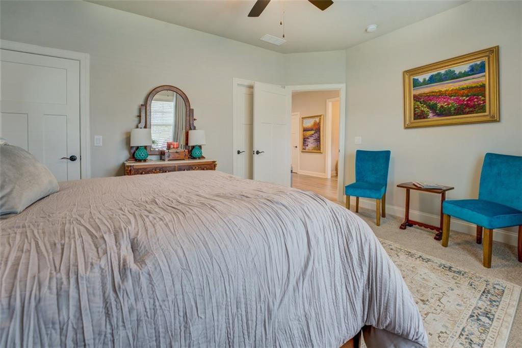 616 Haven Way Monroe, GA 30655 - Photo 24 of 40 a bedroom with a bed and a chair