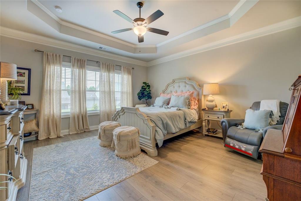 616 Haven Way Monroe, GA 30655 - Photo 26 of 40 a spacious bedroom with a bed couch and a window