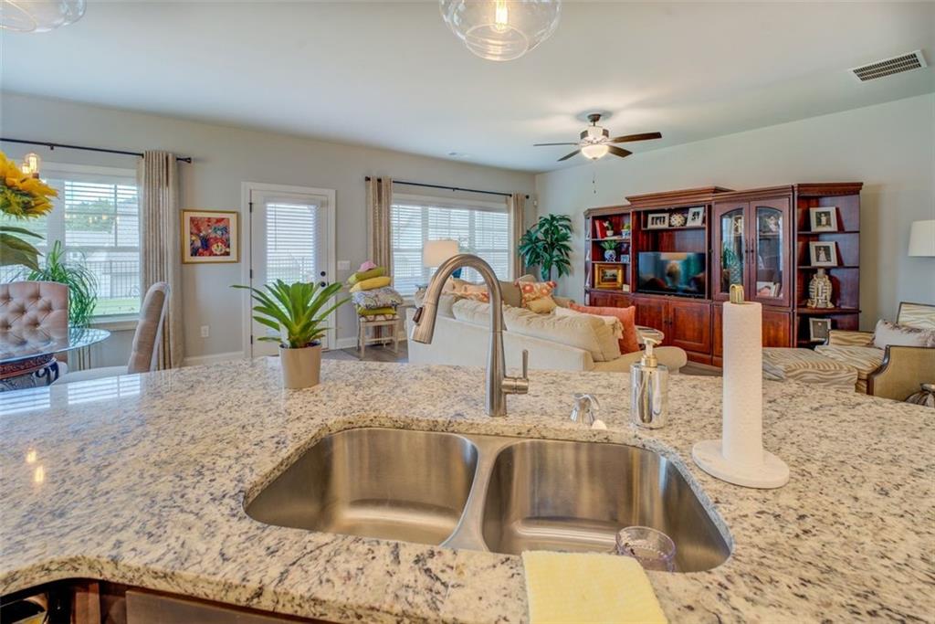616 Haven Way Monroe, GA 30655 - Photo 8 of 40 a kitchen with a faucet a sink and living room view