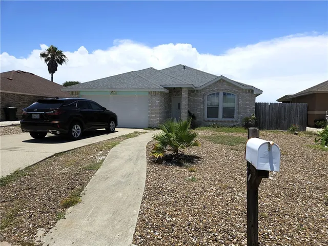 a view of a house with a yard and sitting area