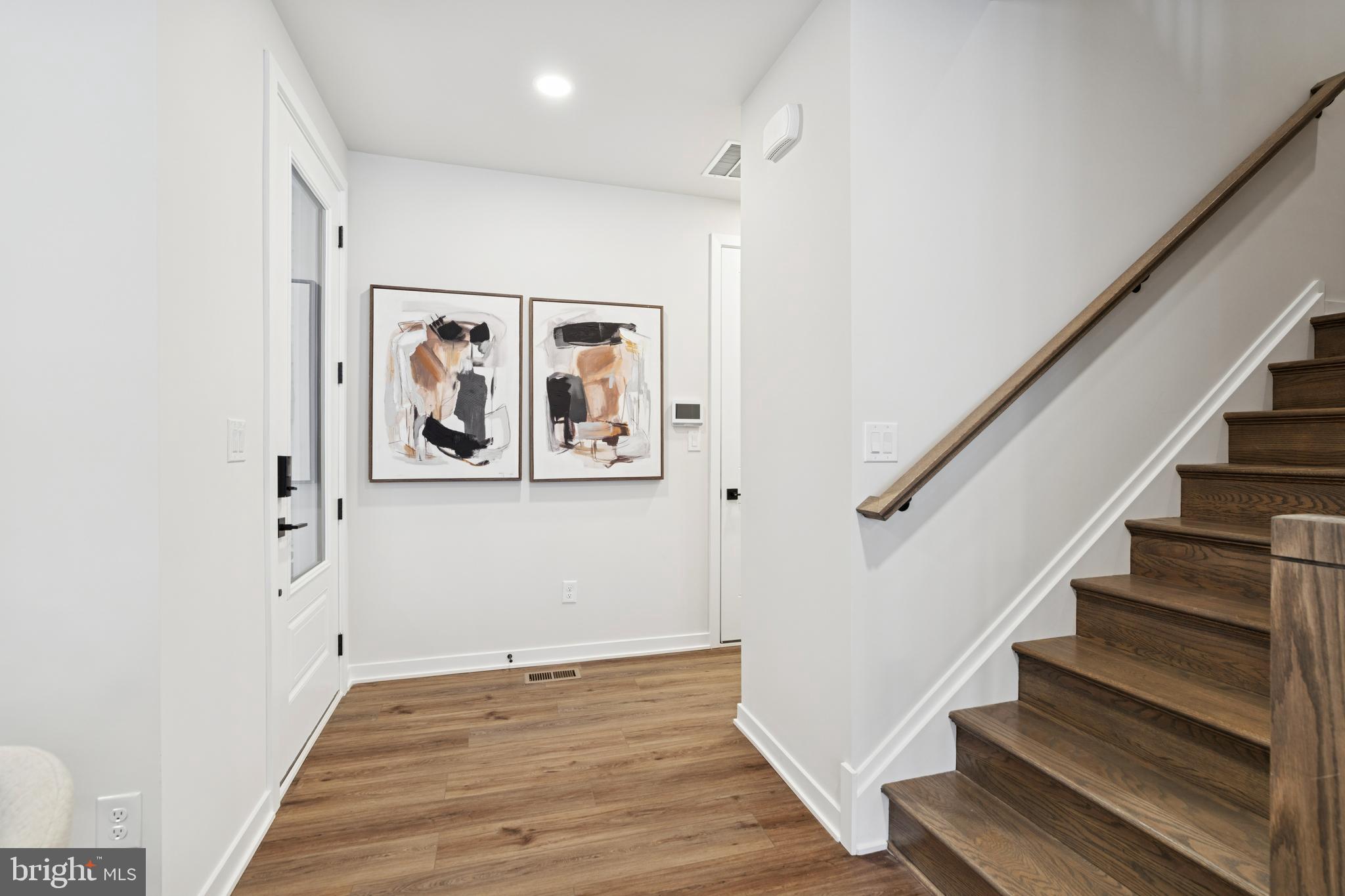 321 Gilman Street Malvern, PA 19355 - Photo 17 of 25 a view of staircase with wooden floor and lots of frames on wall
