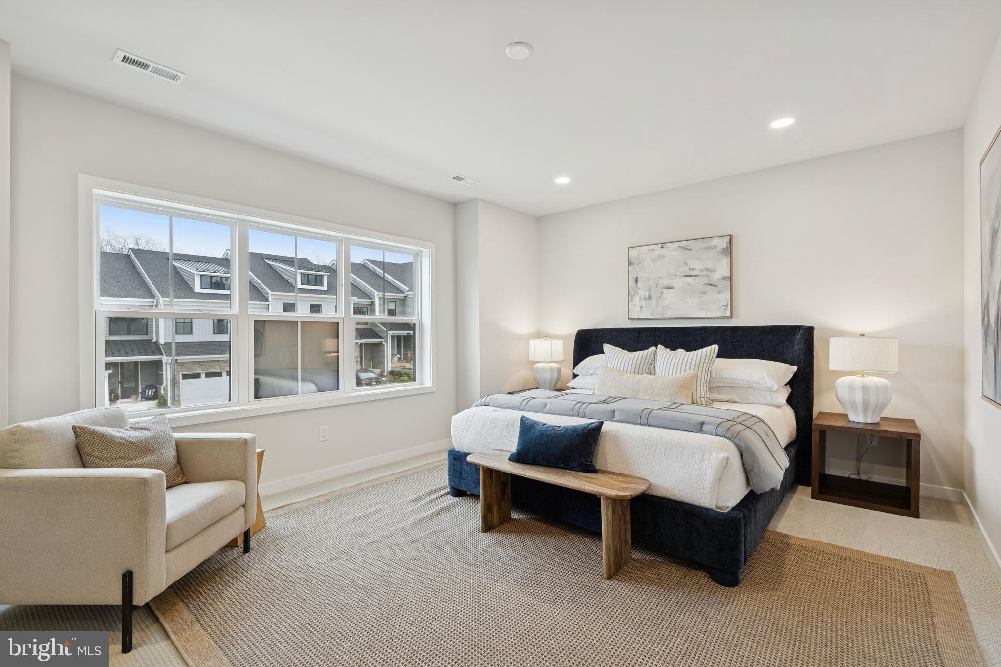 321 Gilman Street Malvern, PA 19355 - Photo 20 of 25 a spacious bedroom with a bed a couch and a window