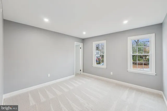 a spacious bedroom with a large bed and a window