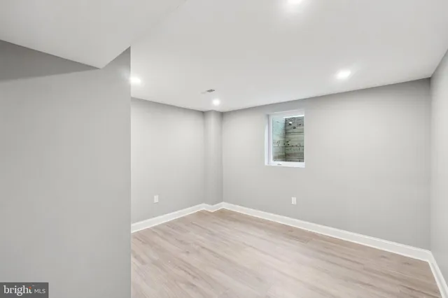 a bathroom with a sink vanity mirror and toilet