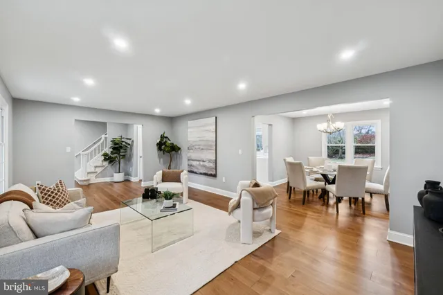a view of a dining room with furniture wooden floor and a chandelier