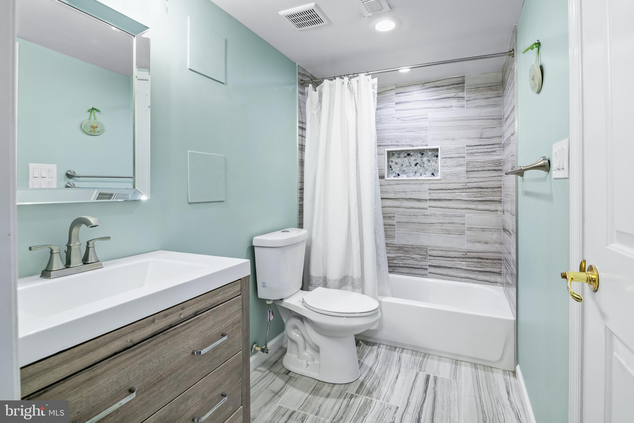 6308 Ivymount Road Baltimore, MD 21209 - Photo 21 of 22 a bathroom with a sink a toilet and shower