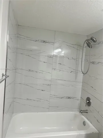 a bathroom with a shower and a bathtub