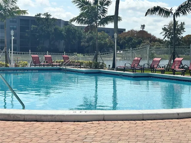 a small pool with a table and chairs