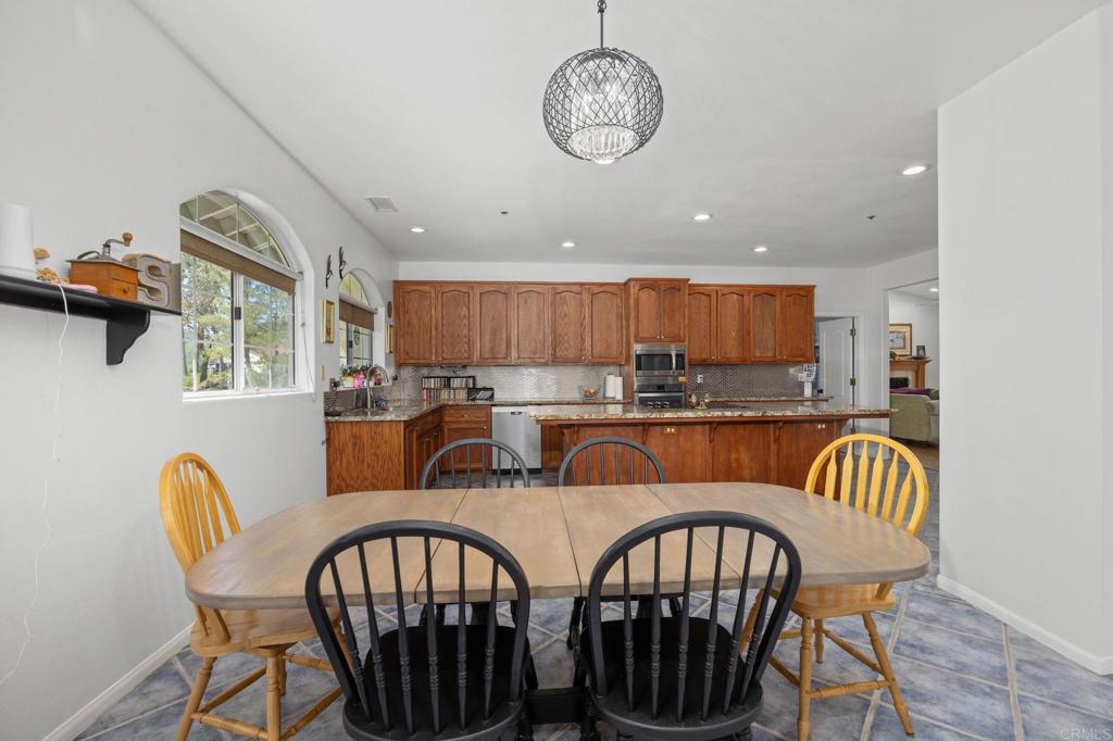 7635 Little Creek Road San Marcos, CA 92078 - Photo 12 of 48 a view of a dining room with furniture window and wooden floor