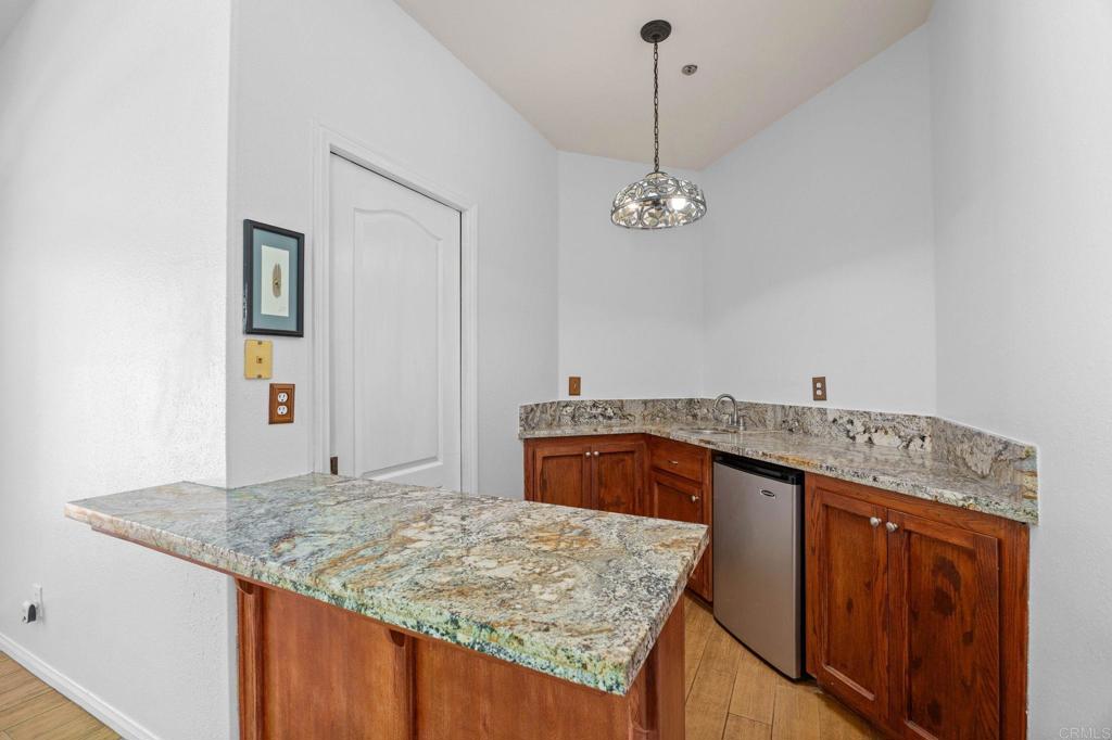 7635 Little Creek Road San Marcos, CA 92078 - Photo 16 of 48 a view of kitchen island stainless steel appliances granite countertop living room