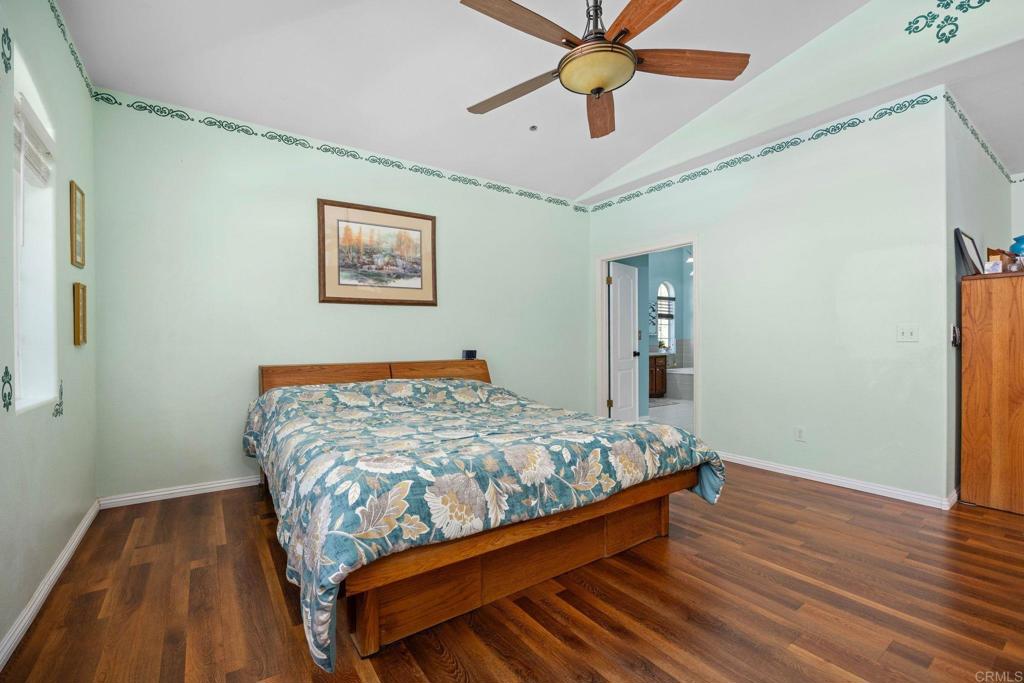7635 Little Creek Road San Marcos, CA 92078 - Photo 19 of 48 a bedroom with bed and wooden floor