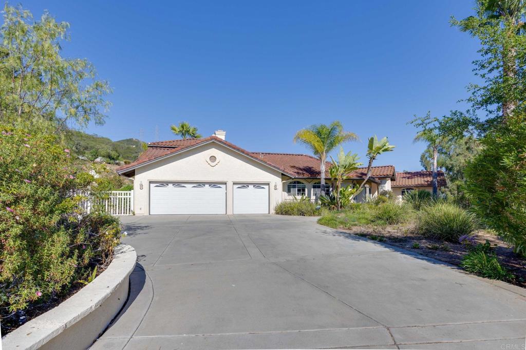 7635 Little Creek Road San Marcos, CA 92078 - Photo 3 of 48 a view of a house with a yard and potted plants