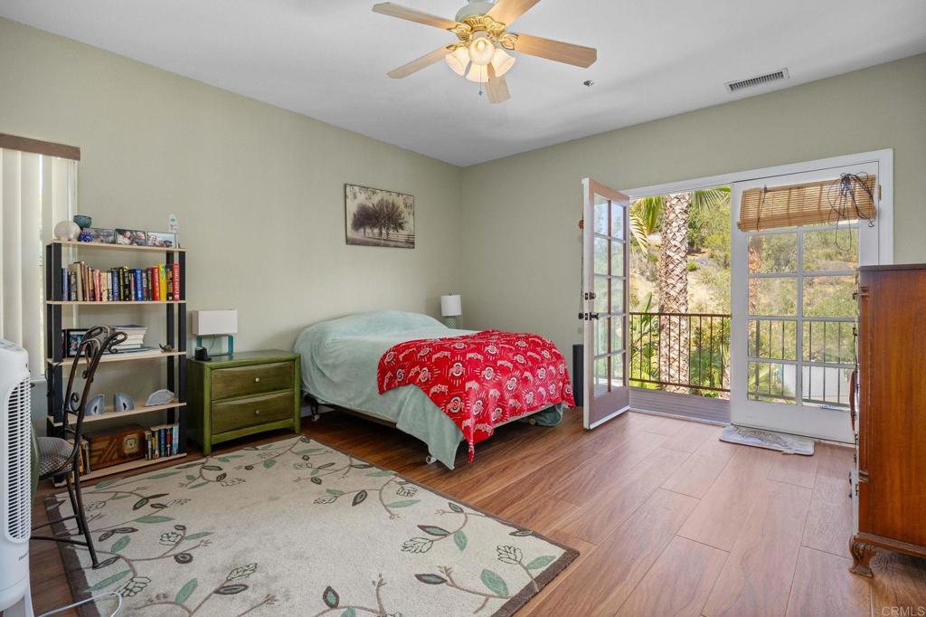 7635 Little Creek Road San Marcos, CA 92078 - Photo 34 of 48 a bedroom with a bed dresser and a window