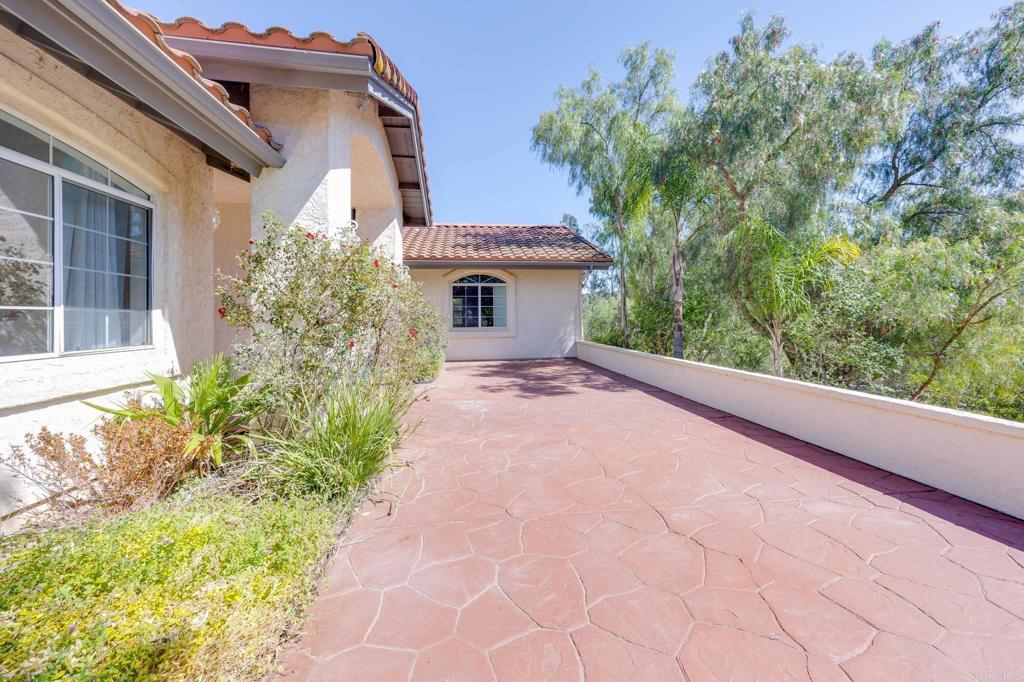 7635 Little Creek Road San Marcos, CA 92078 - Photo 38 of 48 a view of a house with a yard and potted plants