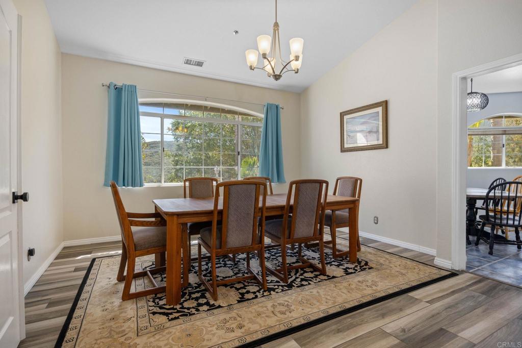 7635 Little Creek Road San Marcos, CA 92078 - Photo 7 of 48 a view of a dining room with furniture window and wooden floor