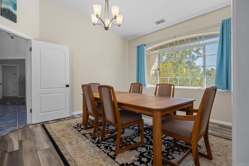 7635 Little Creek Road San Marcos, CA 92078 - Photo 8 of 48 a view of a dining room with furniture window and wooden floor