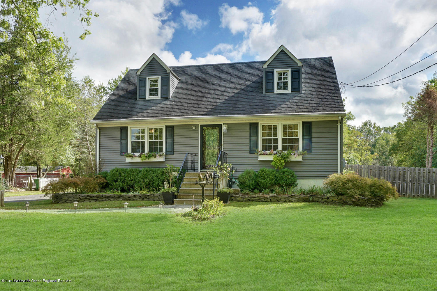 49 Evergreen Drive Jackson, NJ 08527 - Photo 26 of 50 a front view of a house with a yard and trees